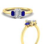 Load image into Gallery viewer, 0.25-ct-emerald-cut-three-stone-sapphire-engagement-ring-in-yellow-gold-fdenr9299emgsablangle3-0.25ct-nl-yg.jpg