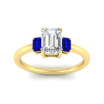 Load image into Gallery viewer, 0.25-ct-emerald-cut-three-stone-sapphire-engagement-ring-in-yellow-gold-fdenr9299emgsablangle5-0.25ct-nl-yg.jpg