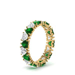 Load image into Gallery viewer, 4-carat-heart-eternity-diamond-anniversary-band-with-emerald-in-yellow-gold-FDEWB8439GEMGRANGLE2-NL-YG