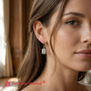 Load image into Gallery viewer, 4-ct-emerald-cut-diamond-drop-earrings-in-yellow-gold-fdear11236em-model-1