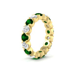 Load image into Gallery viewer, 4.25-carat-round-diamond-and-emerald-bezel-droplet-wedding-band-in-yellow-gold-FD8072ROBGEMGRANGLE2-4.25CT-NL-YG?v=1751956673