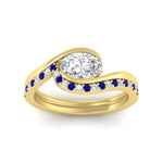 Load image into Gallery viewer, east-west-oval-sapphire-wedding-band-ring-set-in-yellow-gold-fdens7806ovgsablangle5-nl-yg.jpg?v=1759991829