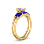 Load image into Gallery viewer, oval-shaped-bar-set-sapphire-ring-with-matching-3-baguette-wedding-band-in-yellow-gold-FDENS100OVGSABLANGLE2-NL-YG