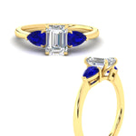Load image into Gallery viewer, pear-diamond-cathedral-emerald-cut-engagement-ring-with-sapphire-in-yellow-gold-fdenr9210emrgsablangle3-nl-yg