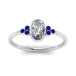 Load image into Gallery viewer, petite-bezel-set-oval-shaped-diamond-engagement-ring-with-sapphire-in-white-gold-FD9175OVRGSABLANGLE5-NL-WG