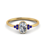 Load image into Gallery viewer, petite-bezel-set-oval-shaped-diamond-engagement-ring-with-sapphire-in-yellow-gold-FD9175OVRGSABL-NL-YG
