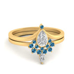 Load image into Gallery viewer, tiara-pear-bezel-blue-topaz-wedding-ring-set-in-yellow-gold-FD1046PEGICBLTO-NL-YG_3169704c-9583-4e0d-a8a6-a1cbea6d6b4f?v=1761911441