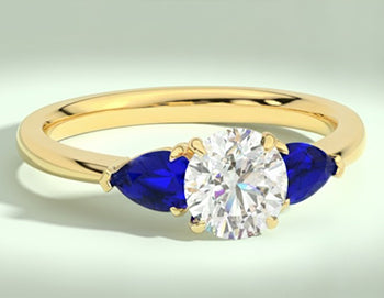Round 3 stone diamond ring with pear shape accent stones