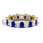 Load image into Gallery viewer, 3-carat-oval-diamond-full-eternity-band-with-blue-saphhire-in-yellow-gold-fdewb8324ovgsablsleep-4.00x3.00mm-nl-yg-hw