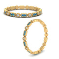 Thumbnail 110 - art-deco-thin-stacking-diamond-eternity-band-with-blue-topaz-in-yellow-gold-FDEWB2139GICBLTOANGLE3-NL-YG.jpg