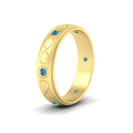 Load image into Gallery viewer, bezel-set-blue-topaz-mens-wedding-band-in-yellow-gold-fdm1284gicbltoangle2-nl-yg
