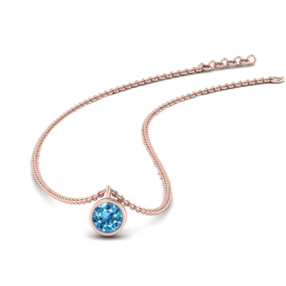 Bezel set round cut- blue topaz pendant in RG