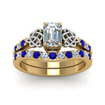 Load image into Gallery viewer, celtic-emerald-cut-diamond-wedding-ring-set-with-sapphire-in-yellow-gold-FDENS2255B1EMGSABLANGLE5-NL-YG_c6dbba0f-9d94-4ea7-805f-d8a997664f73?v=1757056978
