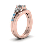 Load image into Gallery viewer, celtic-knot-emerald-cut-diamond-ring-with-plain-band-set-with-blue-topaz-in-rose-gold-FDENS2255B3EMGICBLTOANGLE2-NL-RG?v=1756976734
