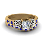 Load image into Gallery viewer, channel-band-princess-cut-diamond-celtic-bridal-set-with-sapphire-in-yellow-gold-FDENS2255B2PRGSABL-NL-YG_0027ebf7-3683-473a-b027-1924c1aa0759?v=1756980497
