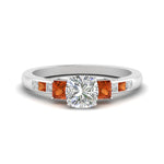 Load image into Gallery viewer, cushion-cut-channel-three-stone-diamond-engagement-ring-with-orange-sapphire-in-white-gold-FDENS205CURGSAOR-NL-WG.jpg
