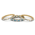Load image into Gallery viewer, diamond-eternity-stacking-band-with-baguette-and-blue-topaz-in-yellow-gold-FD9119GICBLTOANGLE3-NL-YG.jpg
