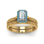 Load image into Gallery viewer, hand-engraved-emerald-cut-halo-diamond-wedding-ring-set-with-blue-topaz-in-yellow-gold-FD8588EMGICBLTOANGLE5-NL-YG_171399d7-a2dc-4735-bd7a-87476fab90dc?v=1757665328

