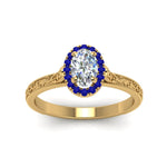 Load image into Gallery viewer, hand-engraved-oval-shaped-halo-diamond-engagement-ring-with-sapphire-in-yellow-gold-FD8588OVRGSABLANGLE5-NL-YG_24235202-754d-4e08-a6ae-c6d92a9e4f8d?v=1757588530
