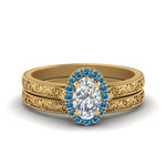 Load image into Gallery viewer, hand-engraved-oval-shaped-halo-diamond-wedding-ring-set-with-blue-topaz-in-yellow-gold-FD8588OVGICBLTO-NL-YG_cbd222ee-af61-41a8-a4db-0a03584da977?v=1757665361
