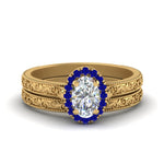 Load image into Gallery viewer, hand-engraved-oval-shaped-halo-diamond-wedding-ring-set-with-sapphire-in-yellow-gold-FD8588OVGSABL-NL-YG_a73b6278-0d25-4b4c-bc03-45f331307098?v=1757665361
