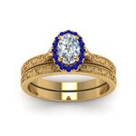Load image into Gallery viewer, hand-engraved-oval-shaped-halo-diamond-wedding-ring-set-with-sapphire-in-yellow-gold-FD8588OVGSABLANGLE5-NL-YG_94600fad-ece7-4331-b102-84b7c45671df?v=1757665361
