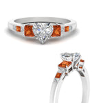 Load image into Gallery viewer, heart-shaped-channel-three-stone-diamond-engagement-ring-with-orange-sapphire-in-white-gold-FDENS205HTRGSAOR-NL-WG.jpg
