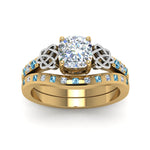 Load image into Gallery viewer, irish-cushion-cut-diamond-bridal-ring-set-with-blue-topaz-in-yellow-gold-FDENS2255B4CUGICBLTOANGLE5-NL-YG_fbd46086-1a6a-464a-8a05-61317ee61690?v=1757052278
