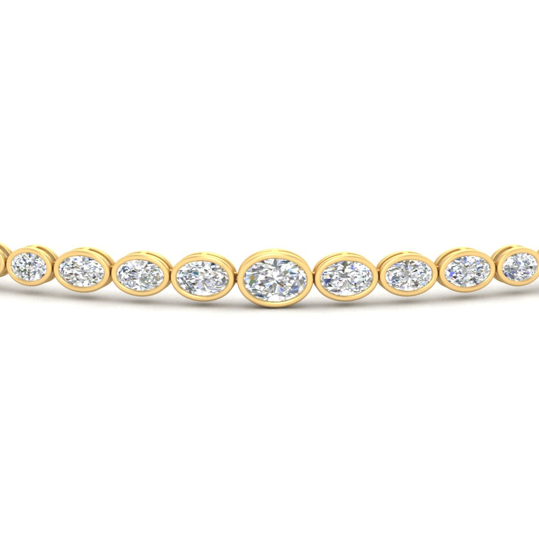 minimalist-bezel-set-oval-diamond-bracelet-in-yellow-gold-fdbrc11733angle5-nl-yg.jpg?v=1776314709