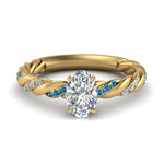 Load image into Gallery viewer, oval-shaped-blue-topaz-twisted-vine-engagement-ring-in-yellow-gold-FD9127OVRGICBLTO-NL-YG
