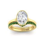 Load image into Gallery viewer, oval-shaped-diamond-bezel-solitaire-ring-with-emerald-band-in-yellow-gold-FD11229OVGEMGRANGLE5-NL-YG_9b58e42e-85fe-4336-a270-2c01da472275.jpg?v=1758702938
