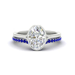 Load image into Gallery viewer, oval-shaped-diamond-bezel-solitaire-ring-with-sapphire-band-in-white-gold-FD11229OVGSABL-NL-WG_df2a17df-9f7c-411d-8148-4d80c5952fdc.jpg?v=1758702938
