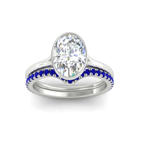 oval-shaped-diamond-bezel-solitaire-ring-with-sapphire-band-in-white-gold-FD11229OVGSABLANGLE5-NL-WG_47ca6d77-9b70-4f97-a841-954c45c6ece8.jpg?v=1758702938