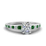 Load image into Gallery viewer, oval-shaped-swirl-engraved-channel-accent-diamond-engagement-ring-with-emerald-in-FD122866OVRGEMGR-NL-WG