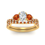 Load image into Gallery viewer, oval-shaped-twisted-floral-prong-orange-sapphire-wedding-set-in-yellow-gold-FD10257OVGSAOR-ANGLE5-NL-YG?v=1756360021
