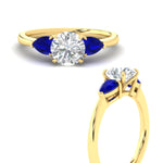 Load image into Gallery viewer, pear-diamond-cathedral-round-cut-engagement-ring-with-sapphire-in-yellow-gold-fdenr9210rorgsablangle3-nl-yg
