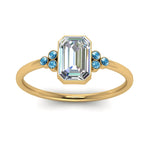 Load image into Gallery viewer, petite-bezel-set-emerald-cut-diamond-engagement-ring-with-blue-topaz-in-yellow-gold-FD9175EMRGICBLTOANGLE5-NL-YG
