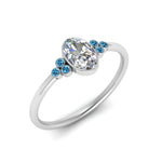 Load image into Gallery viewer, petite-bezel-set-oval-shaped-diamond-engagement-ring-with-blue-topaz-in-white-gold-FD9175OVRGICBLTOANGLE2-NL-WG

