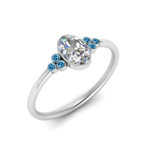 petite-bezel-set-oval-shaped-diamond-engagement-ring-with-blue-topaz-in-white-gold-FD9175OVRGICBLTOANGLE2-NL-WG