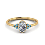 Load image into Gallery viewer, petite-bezel-set-oval-shaped-diamond-engagement-ring-with-blue-topaz-in-yellow-gold-FD9175OVRGICBLTO-NL-YG

