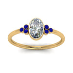 Load image into Gallery viewer, petite-bezel-set-oval-shaped-diamond-engagement-ring-with-sapphire-in-yellow-gold-FD9175OVRGSABLANGLE5-NL-YG
