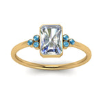 Load image into Gallery viewer, petite-bezel-set-radiant-cut-diamond-engagement-ring-with-blue-topaz-in-yellow-gold-FD9175RARGICBLTOANGLE5-NL-YG
