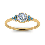 Load image into Gallery viewer, petite-bezel-set-round-cut-diamond-engagement-ring-with-blue-topaz-in-yellow-gold-FD9175RORGICBLTOANGLE5-NL-YG
