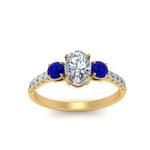 Load image into Gallery viewer, petite-micropave-oval-shaped-three-stone-diamond-engagement-ring-with-sapphire-in-yellow-gold-FD9383OVRGSABL-NL-YG
