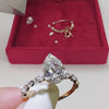 Load and play video in Gallery viewer, pear-shaped-lab-diamond-ring-with-floating-marquise-stones-yellow-gold-FDENS9398R1