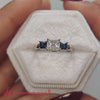 princess-cut-trellis-3-stone-diamond-engagement-ring-with-sapphire-in-18k-white-gold--FDENR578-720