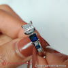 Load image into Gallery viewer, princess-cut-channel-three-stone-diamond-engagement-ring-with-sapphire-in-white-gold-FDENS205PRRGSABL-NL-WG.jpg