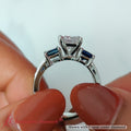 Thumbnail 28 - princess-cut-channel-three-stone-diamond-engagement-ring-with-sapphire-in-white-gold-FDENS205-2.jpg