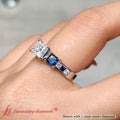 Thumbnail 29 - princess-cut-channel-three-stone-diamond-engagement-ring-with-sapphire-in-white-gold-FDENS205-2.jpg