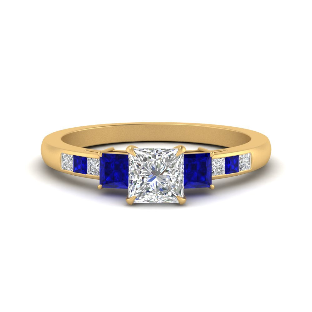 princess-cut-channel-three-stone-diamond-engagement-ring-with-sapphire-in-yellow-gold-FDENS205PRRGSABL-NL-YG.jpg